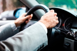 image of driver with hands on the steering wheel